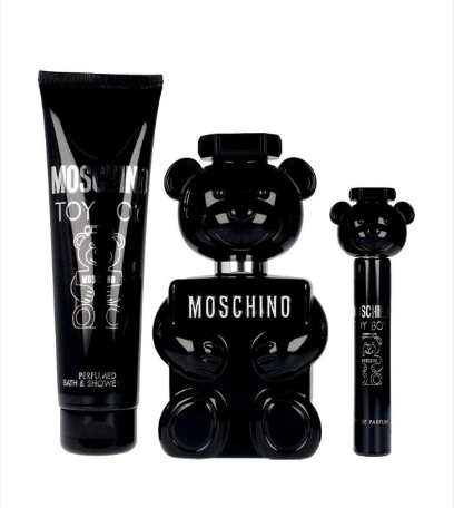 Moschino Toy Boy cologne gift set featuring a black bear-shaped perfume bottle, a black tube of bath & shower foam, and a small black spray bottle, all on a white background.