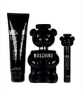 Moschino Toy Boy cologne gift set featuring a black bear-shaped perfume bottle, a black tube of bath & shower foam, and a small black spray bottle, all on a white background.