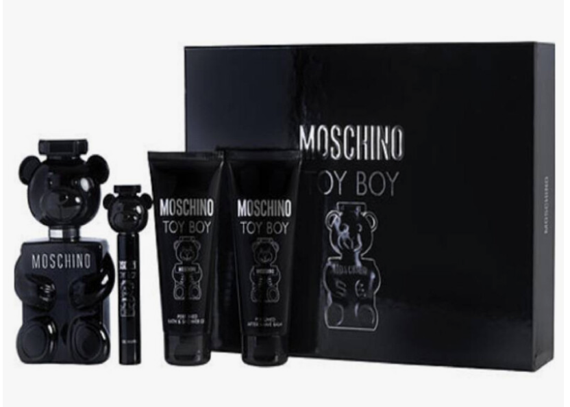 Moschino Toy Boy cologne gift set featuring a black teddy bear-shaped perfume bottle, a smaller matching spray bottle, two black body care tubes with teddy bear graphics, and a large black presentation box with 'MOSCHINO TOY BOY' printed in silver.