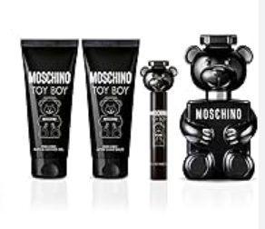 Moschino Toy Boy fragrance gift set featuring a black bear-shaped perfume bottle, a black tube, and a black spray bottle with white text on a white background.