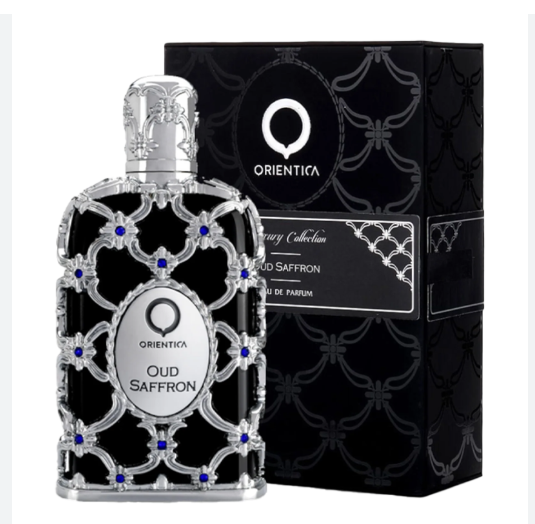 Orienta Oud Saffron Eau de Parfum bottle with a silver filigree design and blue gem accents, shown next to its black patterned packaging box.