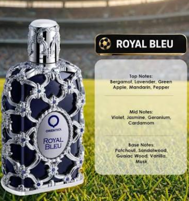 A bottle of Oriental Royal Bleu perfume is shown next to a scent notes card on a blurred green field background. The bottle is dark blue with an ornate silver filigree pattern and a silver cap.