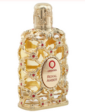 Orientika Royal Amber perfume bottle with an ornate gold filigree design, red jewel accents, and a gold cap on a white background.