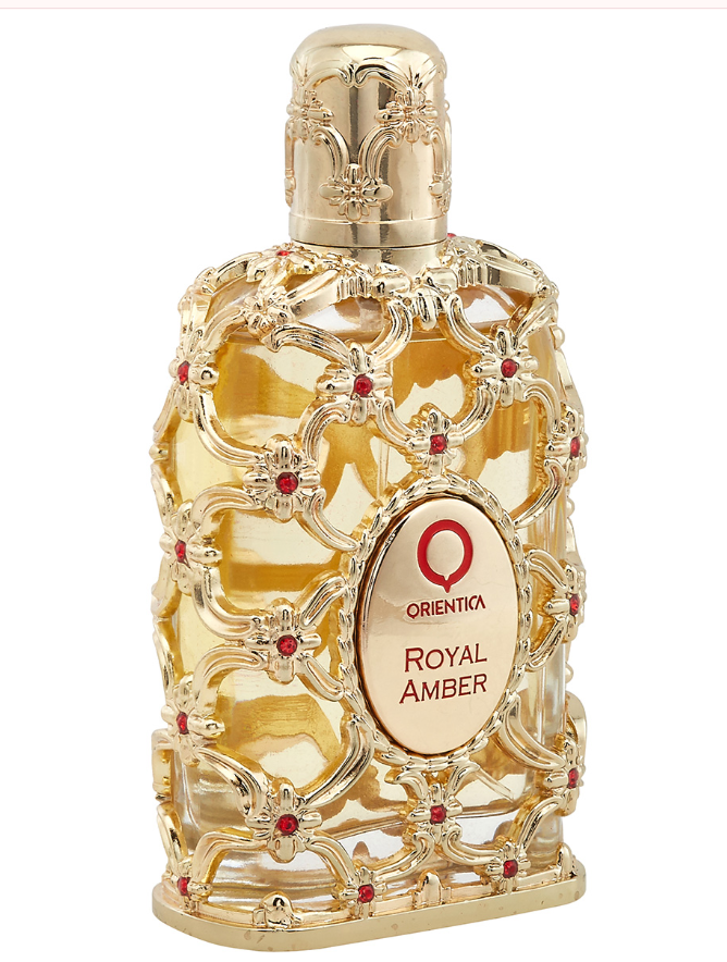 Orientika Royal Amber perfume bottle with an ornate gold filigree design, red jewel accents, and a gold cap on a white background.