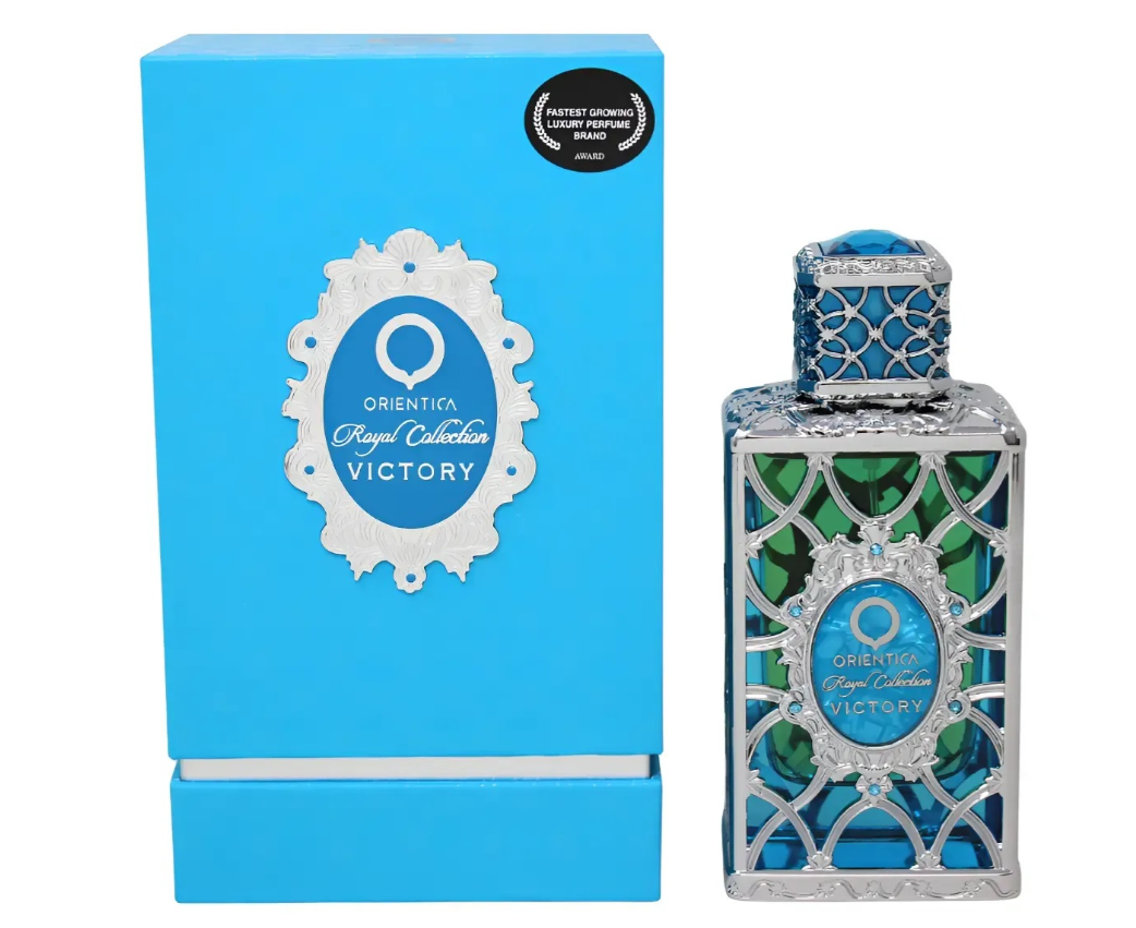 Orientica Royal Collection Victory perfume bottle with a silver and blue geometric cage design, shown next to its bright blue packaging box.