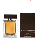 Dolce & Gabbana 'The One' Eau de Toilette perfume bottle with amber liquid next to its dark brown box on a white background.